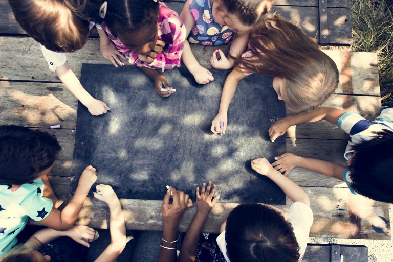 Kids drawing on a chalkboard. (Photo Courtesy/Bigstock)