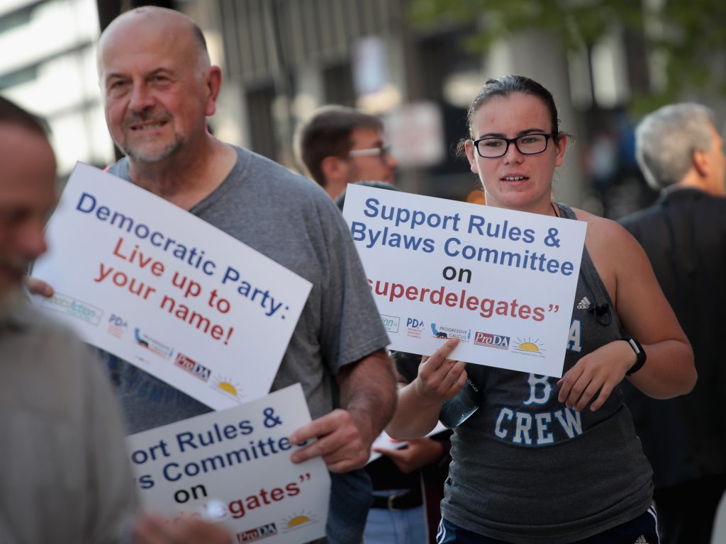 Demonstrators gather outside the Democratic National Committee’s summer meeting to protest the use of “superdelegates” in the party’s presidential nomination process. The DNC voted to drastically reduce their role this weekend. Demonstrators gather outside the Democratic National Committee's summer meeting to protest the use of