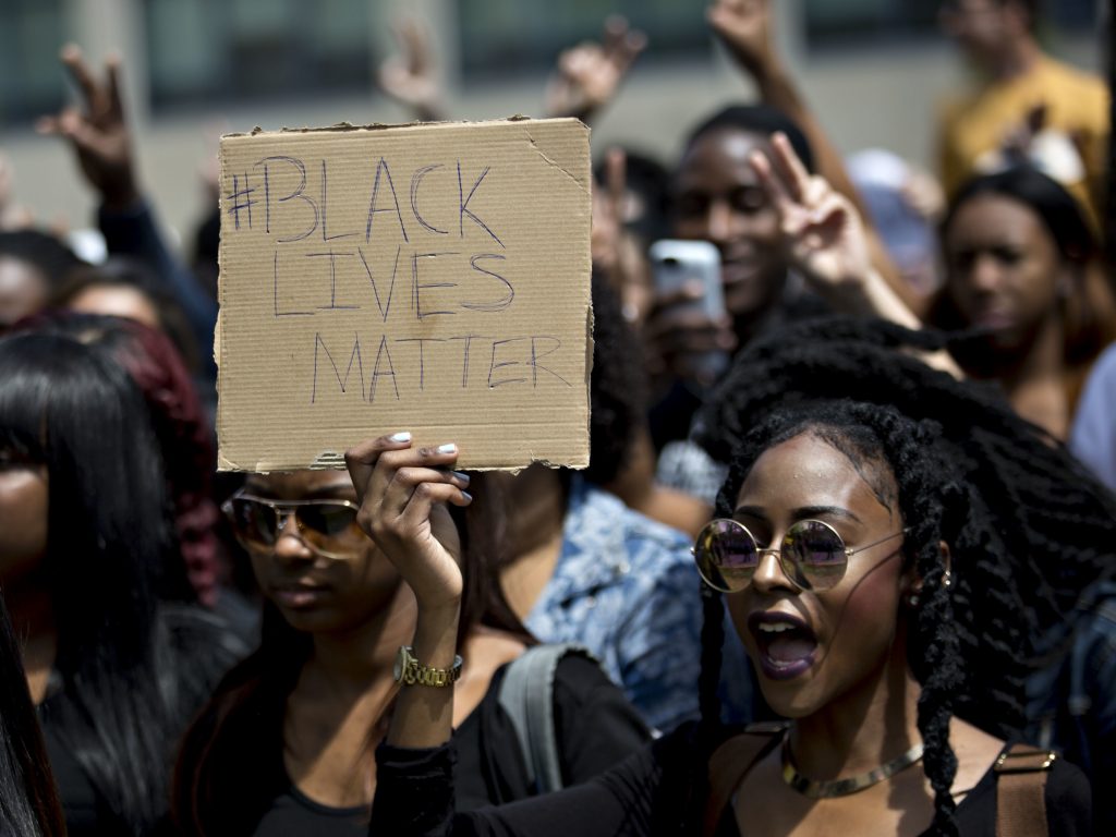A demonstrator holds a “Black Lives Matter” sign while protesting then-presidential candidate Donald Trump in 2016. The hashtag started five years ago and is an “archetypal” example of a hashtag tied to political issues or causes. A demonstrator holds a
