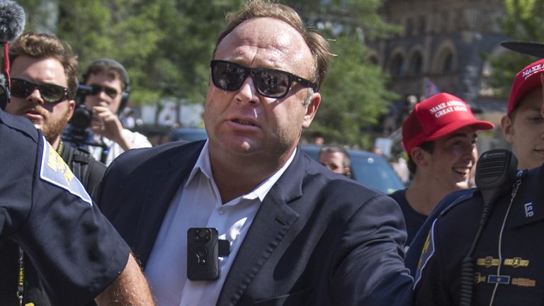 Alex Jones and his Infowars channels have been removed from YouTube; Facebook and Apple's iTunes have also deleted most or all of his outlets on their services. He's seen here being escorted from a rally near the 2016 Republican National Convention.
Tom Williams/CQ-Roll Call Inc.
