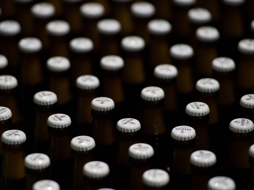 Beer bottles with crowned caps crowd the conveyor belts of a filling plant in the Veltins brewery in Meschede-Grevenstein, western Germany, in January. Beer bottles with crowned caps crowd the conveyor belts of a filling plant in the Veltins brewery in Meschede-Grevenstein, western Germany, in January.
(Rainer Jensen/AFP/Getty Images)