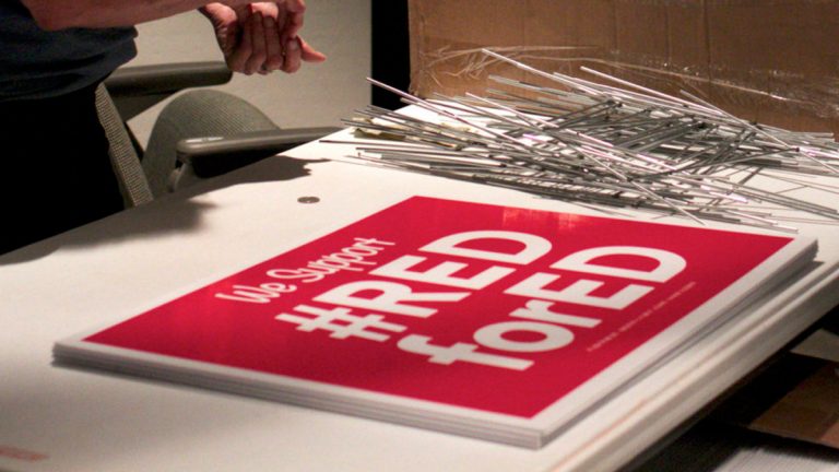 Two days before the walkout, teachers and support staff from across the Flagstaff Unified School District, two hours north of Phoenix, gathered for an information and strategy session. Everyone took home a Red for Ed yard sign. (E. Tammy Kim)
