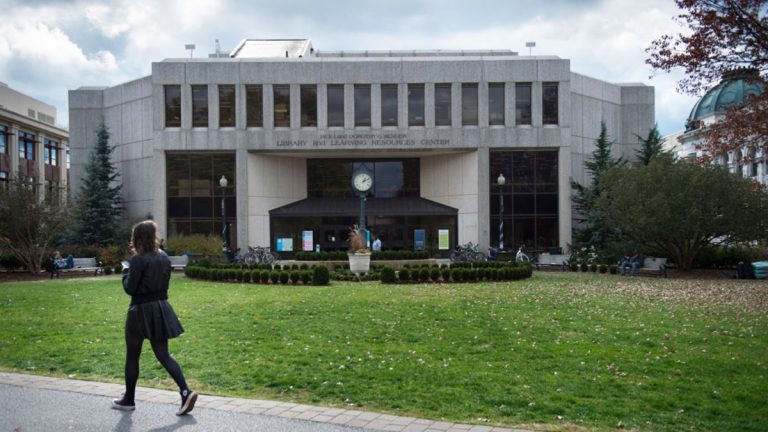 A student walks past the Bender Library on the American University campus in Washington, D.C. American is one of 32 colleges and universities with an accelerated program that lets students earn bachelor’s degrees in thee years instead of four, which one management expert has criticized for helping only undergraduates who are already very well prepared. (Nikki Kahn/The Washington Post via Getty Images)