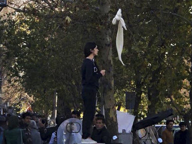 Vida Movahed stands on a telecommunications box, holding a headscarf on a stick in protest against Iran’s mandatory hijab rules, in Tehran in December. Since then, Iranians have staged various protests for women’s rights. Vida Movahed stands on a telecommunications box, holding a headscarf on a stick in protest against Iran's mandatory hijab rules, in Tehran in December. Since then, Iranians have staged various protests for women's rights. (Abaca Press/Sipa USA via AP)