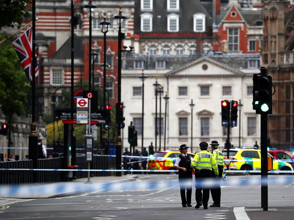 Police stand in the street after a car crashed outside the Houses of Parliament in Westminster, London, Britain, on Tuesday