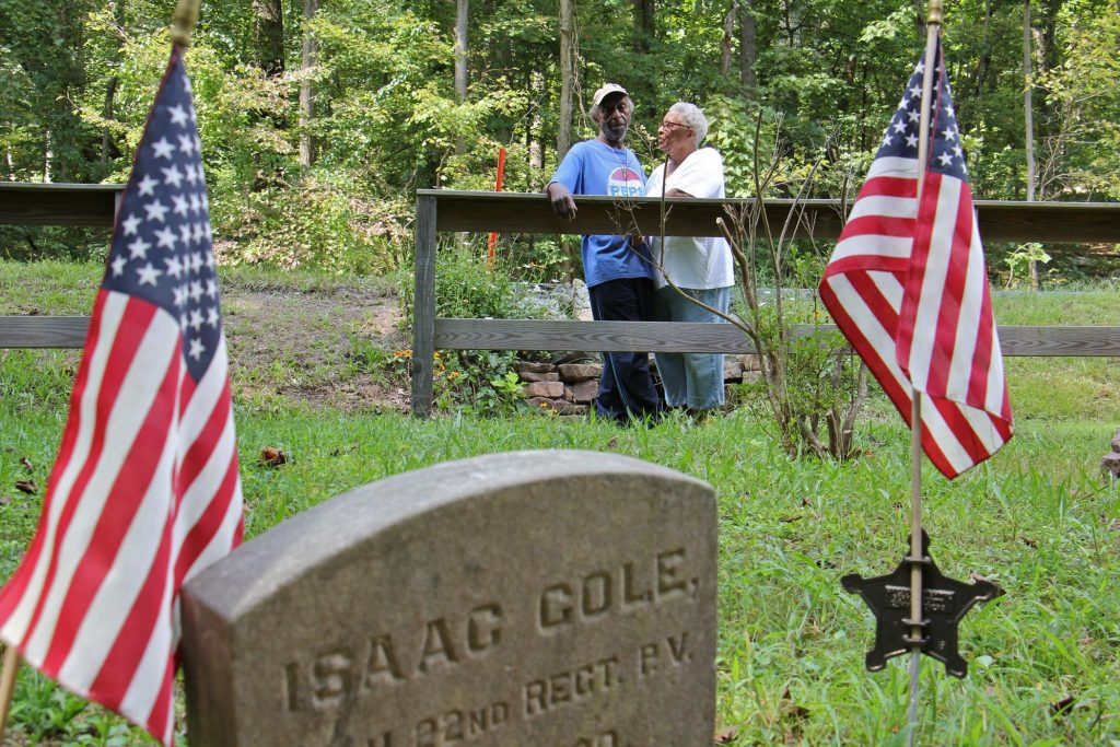 2018 08 30-e lee-john cole barbara cole-douglasville-mount frisby church grave John Cole and his wife, Barbara, visit the tiny graveyard where his great grandfather Isaac Cole, is buried. Isaac Cole was a Civil War veteran and worked as a woodsman for the nearby Hopewell Furnace.