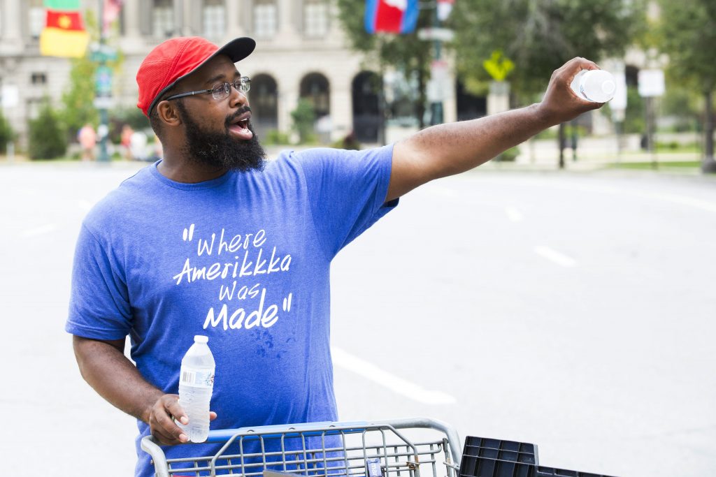 2018 09 01 – rachel wisniewski – Saadiq Garner – philadelphia made in america – unofficial vendors Saadiq Garner, 29, sells water bottles, Gatorade, and rain ponchos outside the Made in America festival Saturday. A car salesman for 13 years, Garner hoped to make some extra cash. (Rachel Wisniewski for WHYY)