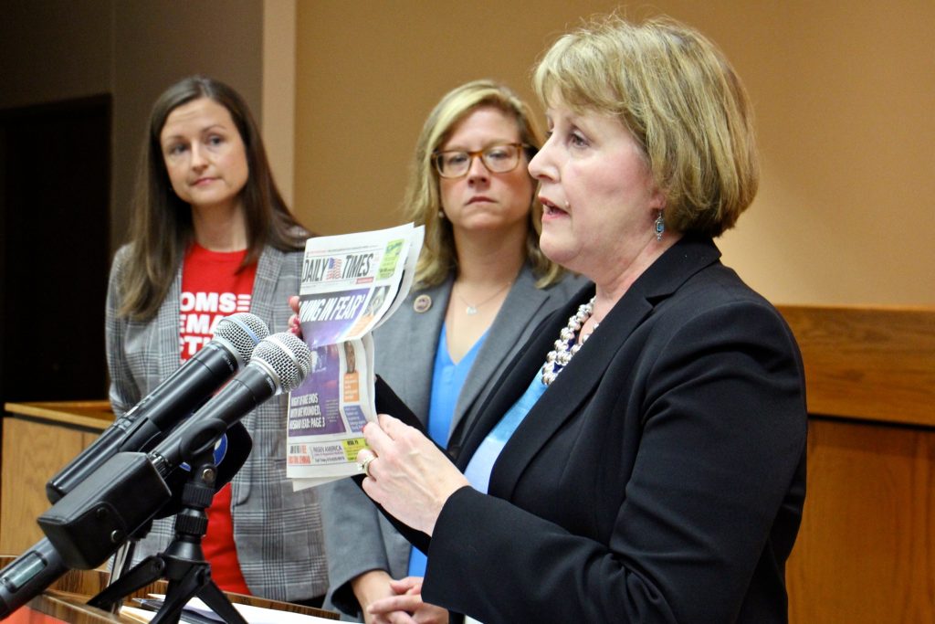 2018 09 04-e lee-sara wallace leanne krueger braneky kathy stone-media county courthouse-domestic abuse gun bill Cathy Stone (right), executive director of the Domestic Abuse Project of Delaware County, holds up a headline-grabbing example of domestic abuse during a press conference to promote Pensylvania House Bill 2060, which prohibits abusers from possessing guns. She is joined by (from left) Sara Wallace of Moms Demand Action and state Rep. Leanne Krueger-Braneky, a co-sponsor of the bill. (Emma Lee/WHYY)