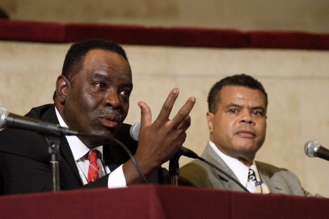 Rev. Owen Gowans, class of 1979, speaks as Theodore Hicks, class of 1976 listens during a forum on the 50th anniversary of the desegregation of Girard College on Tuesday. (Bastiaan Slabbers for WHYY)