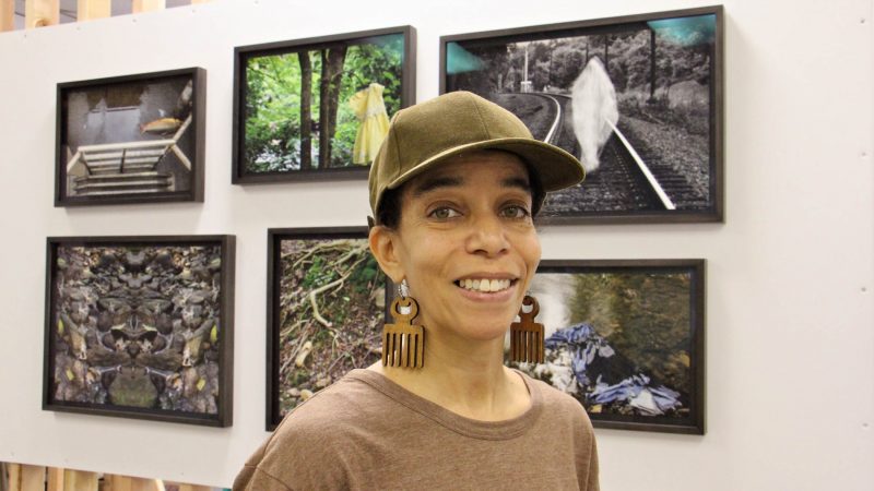 Andrea Walls stands before her exhibit, 
