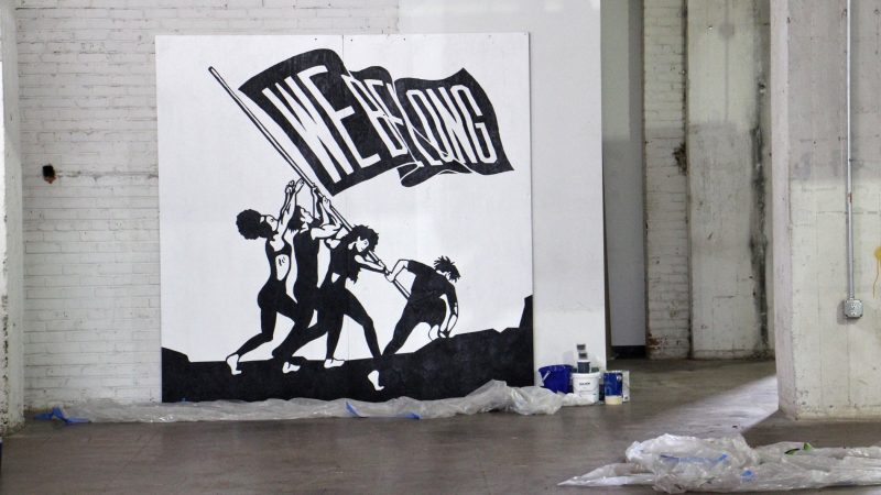 Marisa Velázquez-Rivas evokes the famous World War II photograph of Marines raising a flag on Iwo Jima to illustrate the Latino struggle against marginalization. (Emma Lee/WHYY)