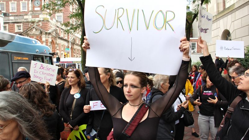 About 200 protesters gather outside the United States Custom House at 200 Chestnut Street to voice their objections to Brett Kavanaugh as a nominee for the U.S. Supreme Court in light of sexual assault allegations. (Emma Lee/WHYY)