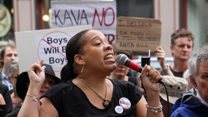 Kadida Kenner, campaign director of Why Courts Matter Pennsylvania, speaks to about 200 protesters gathered outside the United States Custom House at 200 Chestnut Street to voice their objections to Brett Kavanaugh as a nominee for the U.S. Supreme Court in light of sexual assault allegations. (Emma Lee/WHYY)