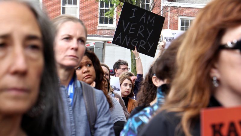 About 200 protesters gather outside the United States Custom House at 200 Chestnut Street to voice their objections to Brett Kavanaugh as a nominee for the U.S. Supreme Court in light of sexual assault allegations. (Emma Lee/WHYY)