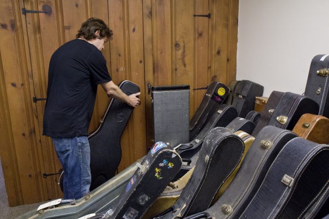 A room filled with customers’ instruments is a testament to Tim Huenke’s craftsmanship at Superior Guitar Works in Flourtown. (Kimberly Paynter/WHYY)
