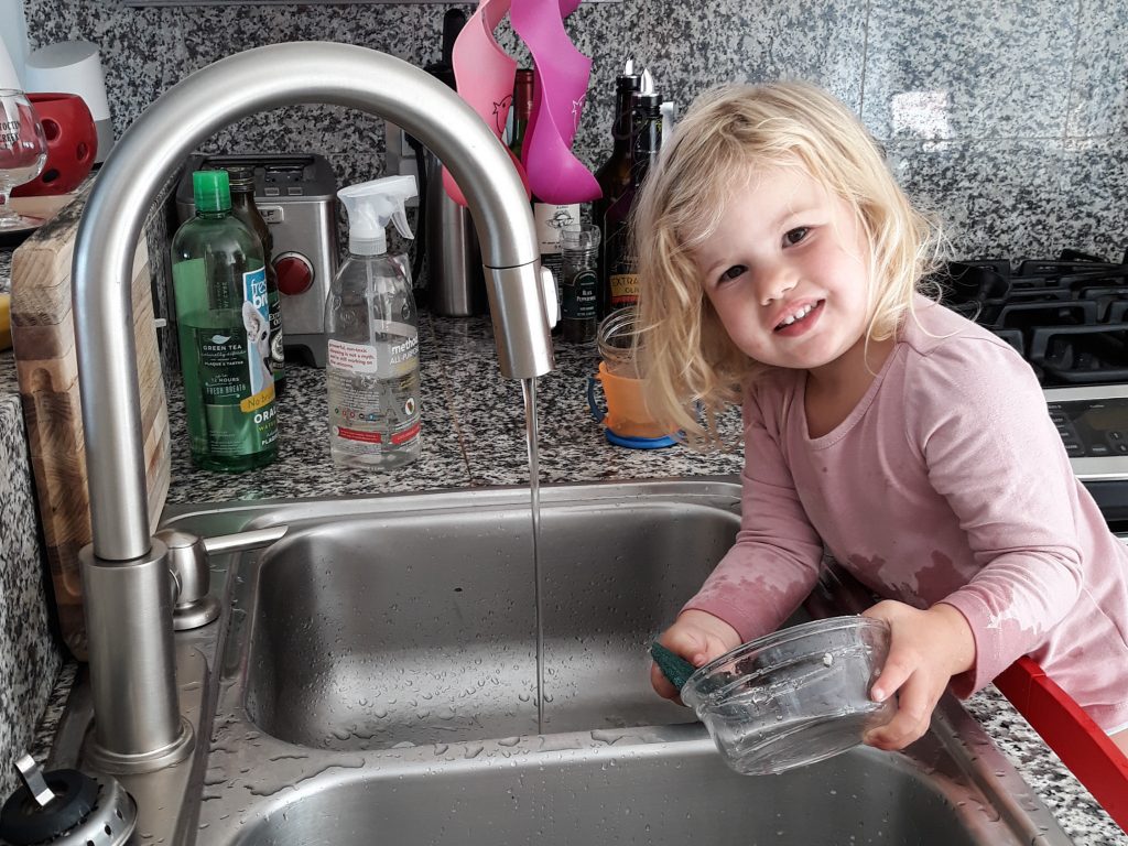 Rosy does dishes. Getting the 2-year-old involved in chores did lead to the kitchen being flooded and dishes being broken. But now she is still eager to help. Rosy does dishes. Getting the 2-year-old involved in chores did lead to the kitchen being flooded and dishes being broken. But now she is still eager to help. (Michaeleen Doucleff/NPR)