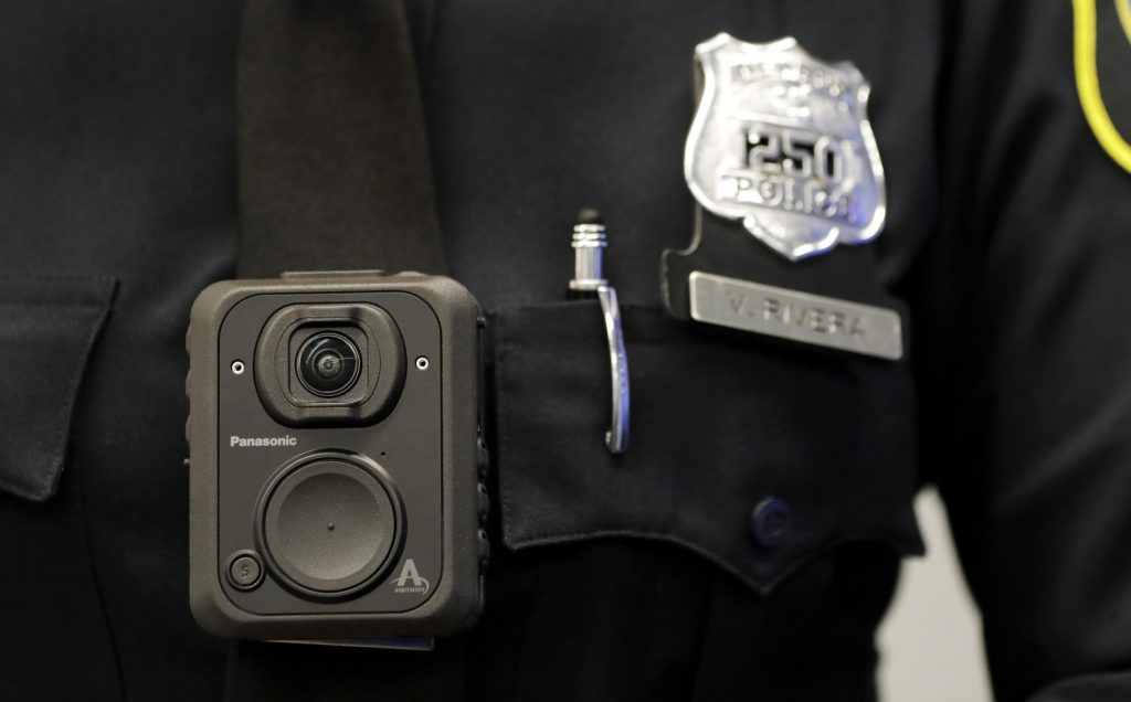 Police Body Cameras FILE - In this April 26, 2017 file photograph, a Newark, N.J. police officer displays how a body cam is worn during a news conference in Newark. (AP Photo/Julio Cortez, File)