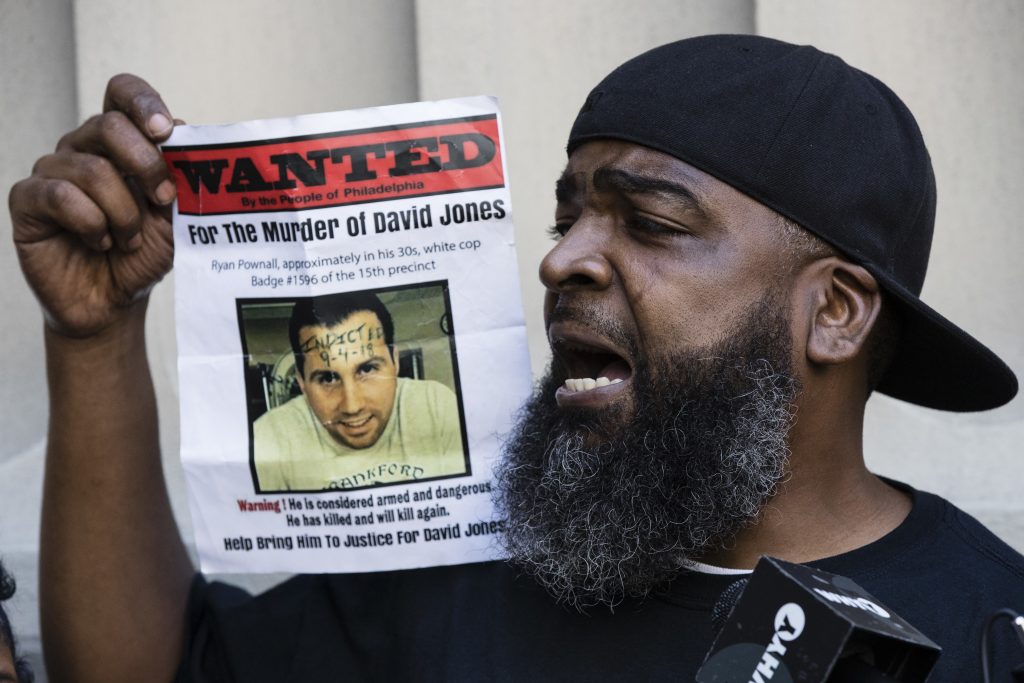 Police Shooting-Officer Charged Isaac Gardner speaks while holding up a photo of David Jones