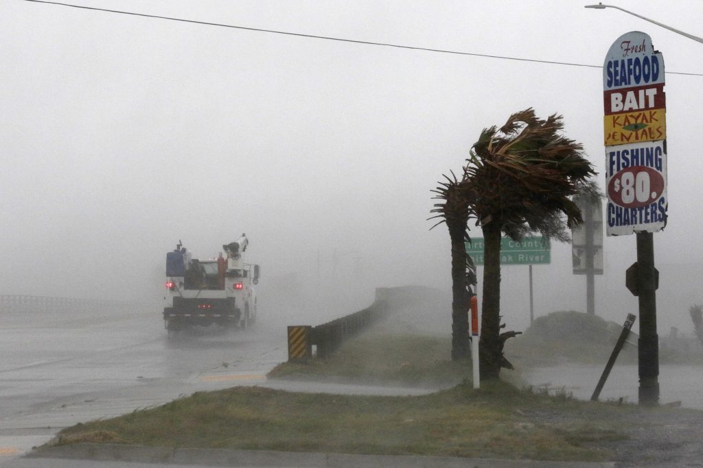 Tropical Weather North Carolina A work truck drives on Hwy 24 as the wind from Hurricane Florence blows palm trees in Swansboro N.C., Thursday, Sept. 13, 2018. (Tom Copeland/AP Photo)