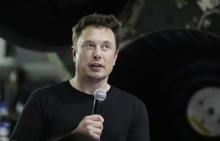 In this Monday, Sept. 17, 2018, file photo Tesla CEO and SpaceX founder and chief executive Elon Musk speaks after announcing Japanese billionaire Yusaku Maezawa as the first private passenger on a trip around the moon in Hawthorne, Calif. Tesla Inc. has turned over documents to the U.S. Justice Department after statements by Musk about taking the company private, the electric car maker confirmed Tuesday, Sept. 18. (Chris Carlson/AP Photo, File)