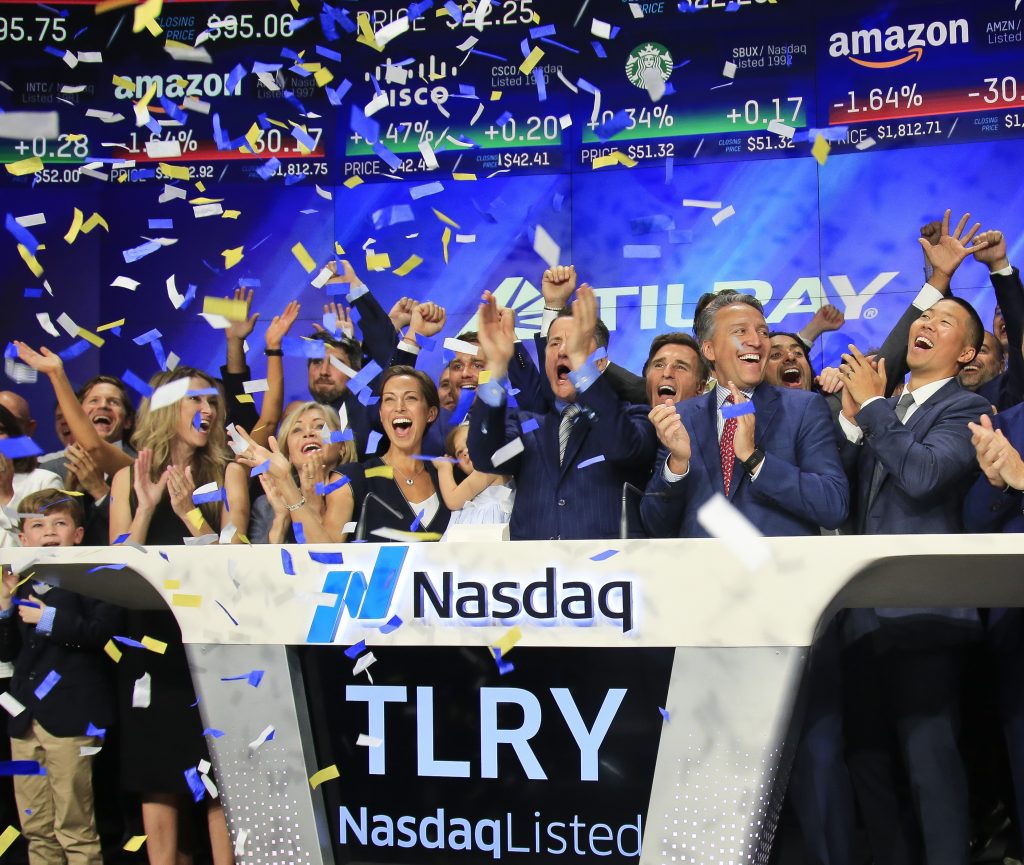 Brendan Kennedy In this July 19, 2018, file photo Brendan Kennedy, (third from right in front), CEO and founder of British Columbia-based Tilray Inc., a major Canadian marijuana grower, leads cheers as confetti falls to celebrate his company's IPO (TLRY) at Nasdaq in New York. Investors are craving marijuana stocks as Canada prepares to legalize pot next month, leading to giant gains for Canada-based companies listed on U.S. exchanges. (Bebeto Matthews/AP Photo, File)