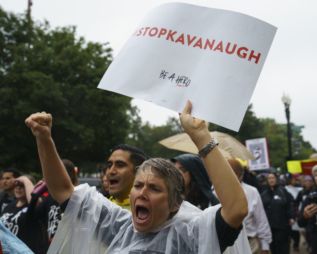 Donald Trump Protesters march from the Supreme Court to Hart Senate Office Building on Capitol Hill in Washington, Monday, Sept. 24, 2018. A second allegation of sexual misconduct has emerged against Judge Brett Kavanaugh, a development that has further imperiled his nomination to the Supreme Court, forced the White House and Senate Republicans onto the defensive and fueled calls from Democrats to postpone further action on his confirmation. President Donald Trump is so far standing by his nominee. (AP Photo/Carolyn Kaster)