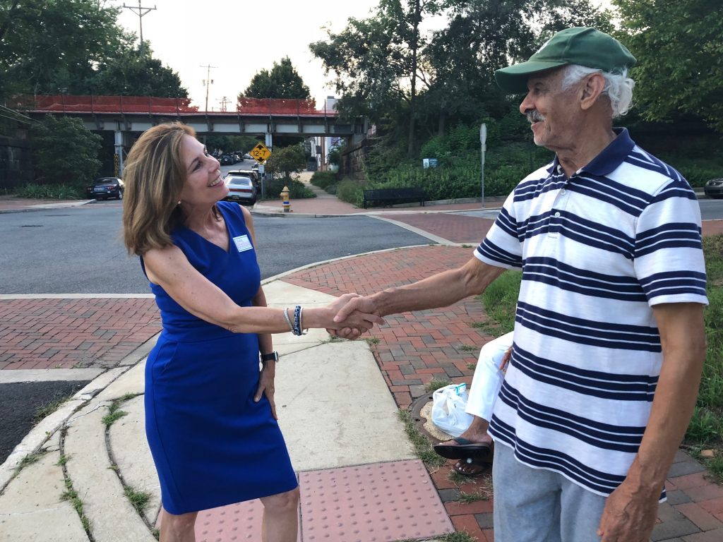 IMG_0063 Kathy Jennings, who won Thursday's Democratic primary for attorney general, shakes hands with a voter about 6:30 p.m. outside Lincoln Towers apartments in Wilmington's Trolley Square neighborhood. (Cris Barrish/WHYY News)