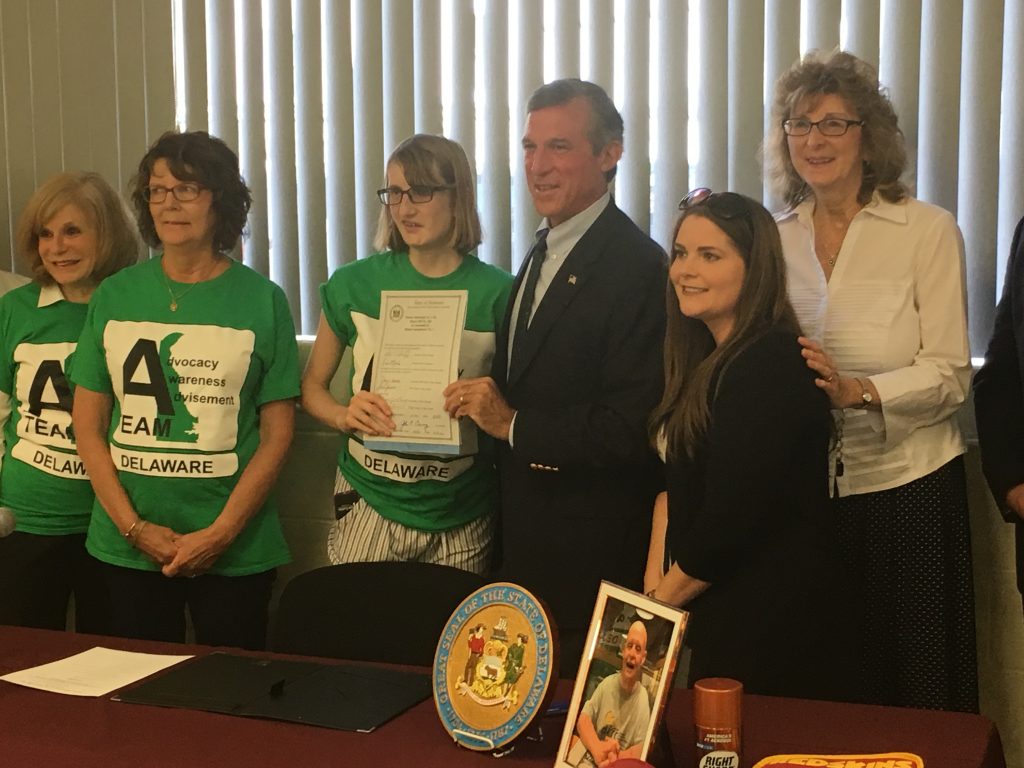 Carney Elwyn Gov. John Carney holds legislation he signed that increases funding for direct-service providers working with Delawareans with intellectual and developmental disabilities. (Mark Eichmann/WHYY)
