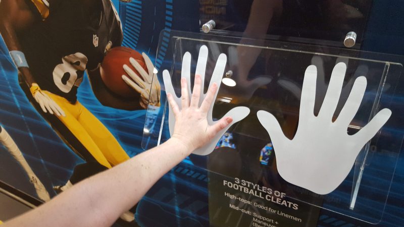 Sara Hoover compares her hand with those of  Dallas Cowboy Dak Prescott. He has the largest hands of any quarterback in the NFL.
 (Sara Hoover for WHYY)