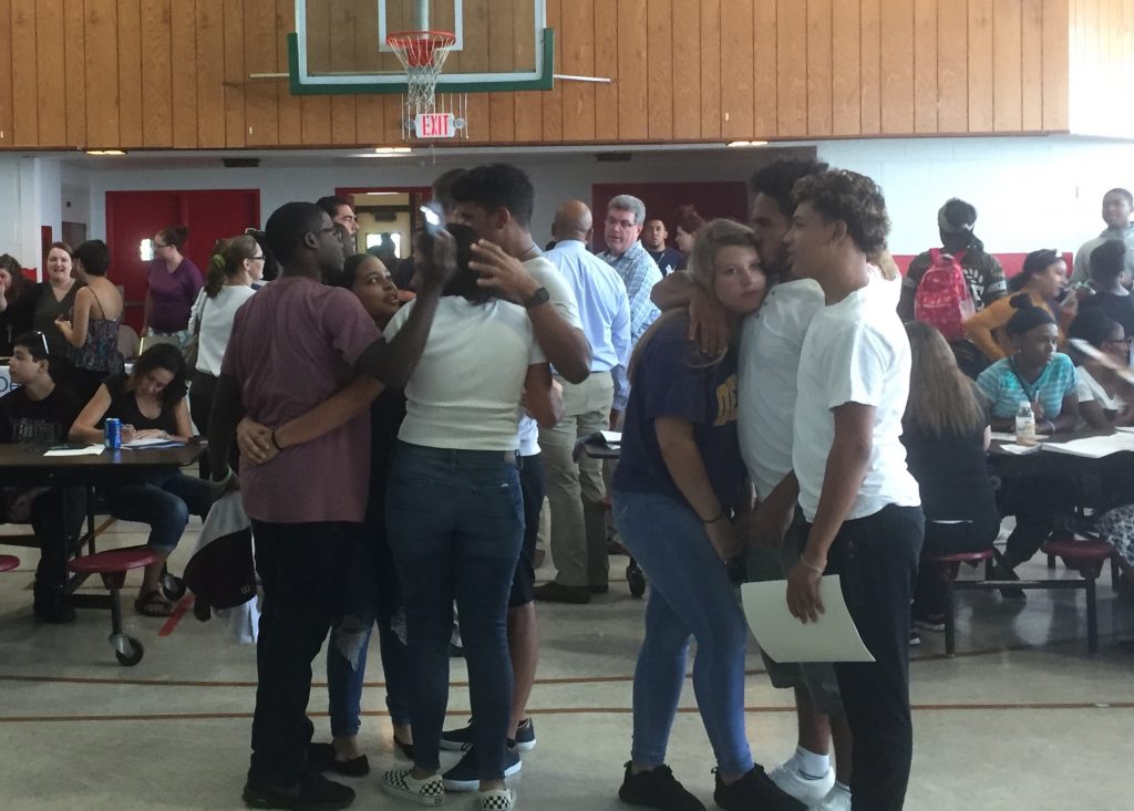 IMG_4637 Students embrace a day after learning their charter school is closing. (Zoe Read/WHYY)