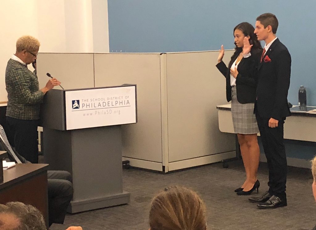 Board of Education President Joyce Wilkerson swears in Alfredo Praticó and Julia Frank as student representatives on the board. (Darryl C. Murphy/The Notebook) 