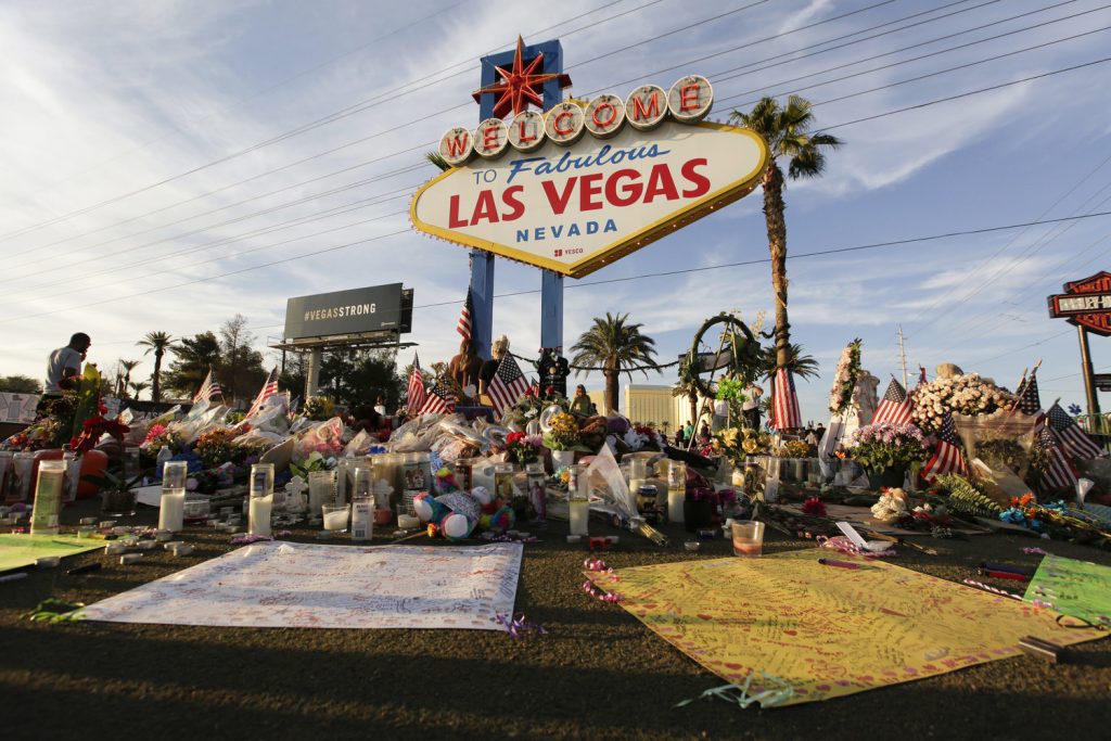 ap_173152508855931_slide-231a9a22bb217b9e1b3ea445a4762ee860956030-s1500-c85 People visit a makeshift memorial for victims of the mass shooting in Las Vegas in October 2017. Fifty-eight crosses were planted in front of the sign to commemorate each of the people killed in the attack. (John Locher/AP)