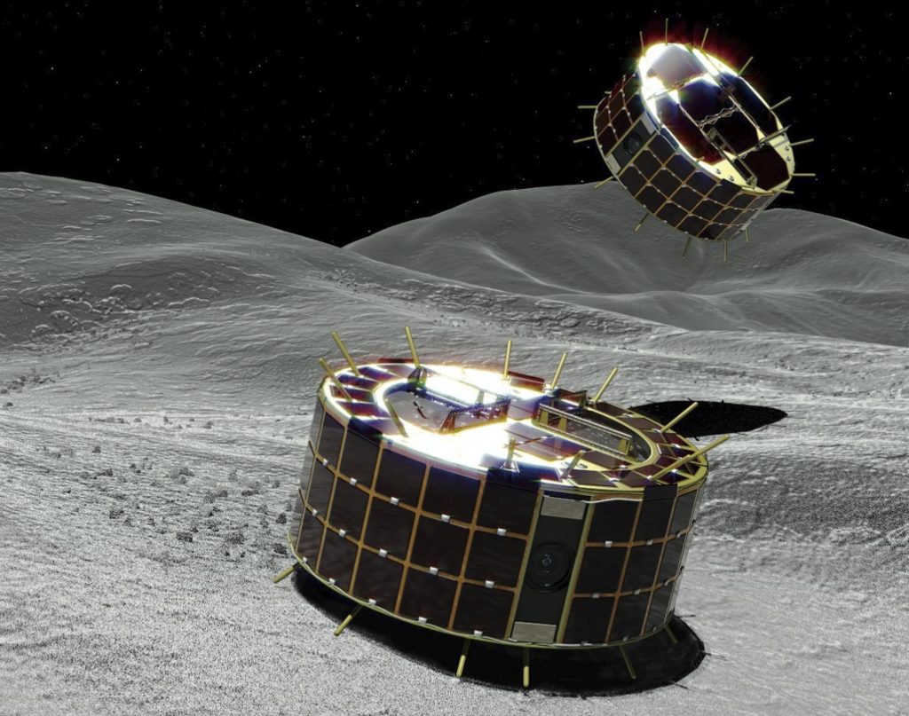 A computer graphic image provided by Japan’s space agency shows two drum-shaped and solar-powered rovers on an asteroid. A Japanese unmanned spacecraft released two small rovers on the asteroid Ryugu last week. A computer graphic image provided by Japan's space agency shows two drum-shaped and solar-powered rovers on an asteroid. A Japanese unmanned spacecraft released two small rovers on the asteroid Ryugu last week.
(Jaxa/AP)
