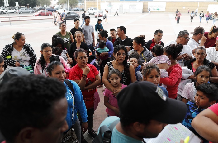 Immigration Separating Families People listen as names are read off a list of who will cross into the United States to begin the process of applying for asylum Thursday, July 26, 2018, near the San Ysidro port of entry in Tijuana, Mexico. As the Trump administration faced a court-imposed deadline Thursday to reunite thousands of children and parents who were forcibly separated at the U.S.-Mexico border, asylum seekers continue to arrive to cities like Tijuana, hoping to plead their cases with U.S. authorities. (AP Photo/Gregory Bull)