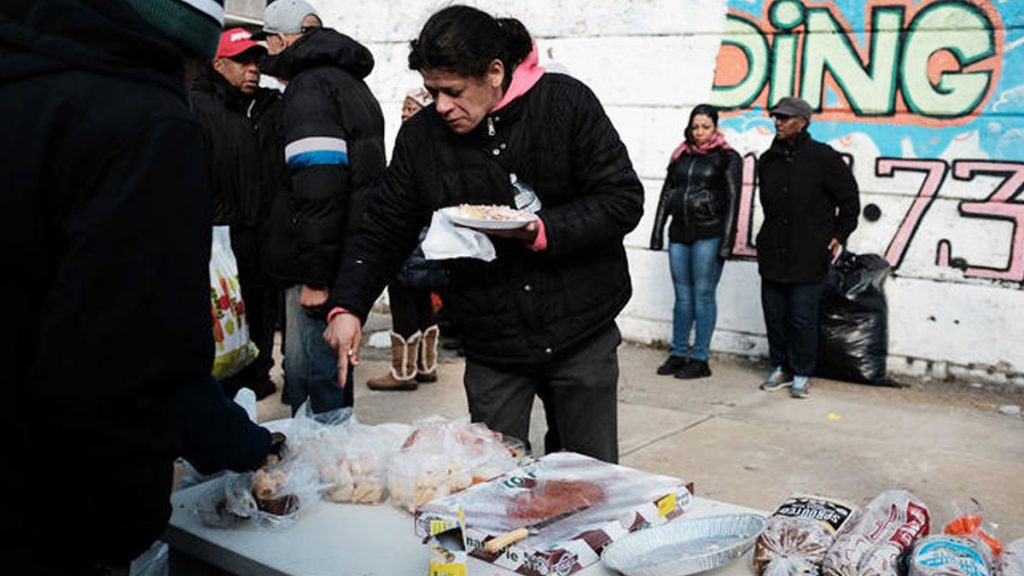 broke16x9 A local church distributes food and clothes to residents in need in the Kensington section in Philadelphia. (Spencer Platt/Getty Images)