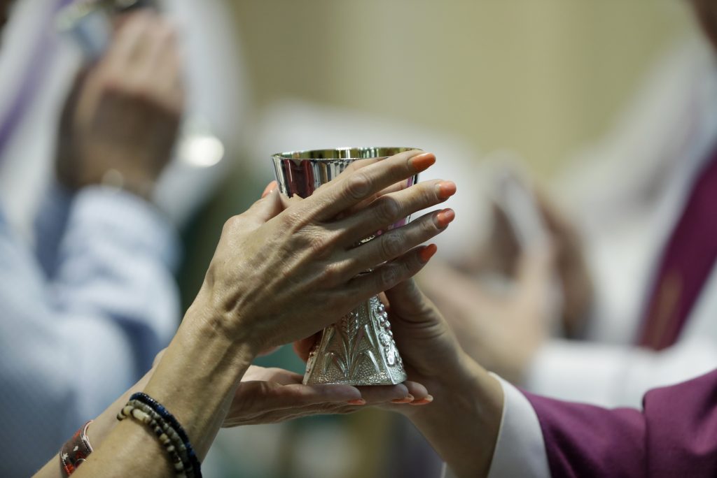 Pennsylvania Dioceses-Sex Abuse Investigation A parishioner celebrates communion at the Cathedral Church of Saint Patrick in Harrisburg, Pa., Friday, Aug. 17, 2018. (Matt Rourke/AP Photo)