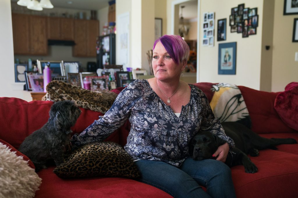 Michel, joined on the couch by longtime pet Blade and service dog Lizzy, says at least three male service members assaulted or molested her between 1990 and 2005. Michel, joined on the couch by longtime pet Blade and service dog Lizzy, says at least three male service members assaulted or molested her between 1990 and 2005. (Claire Harbage/NPR)