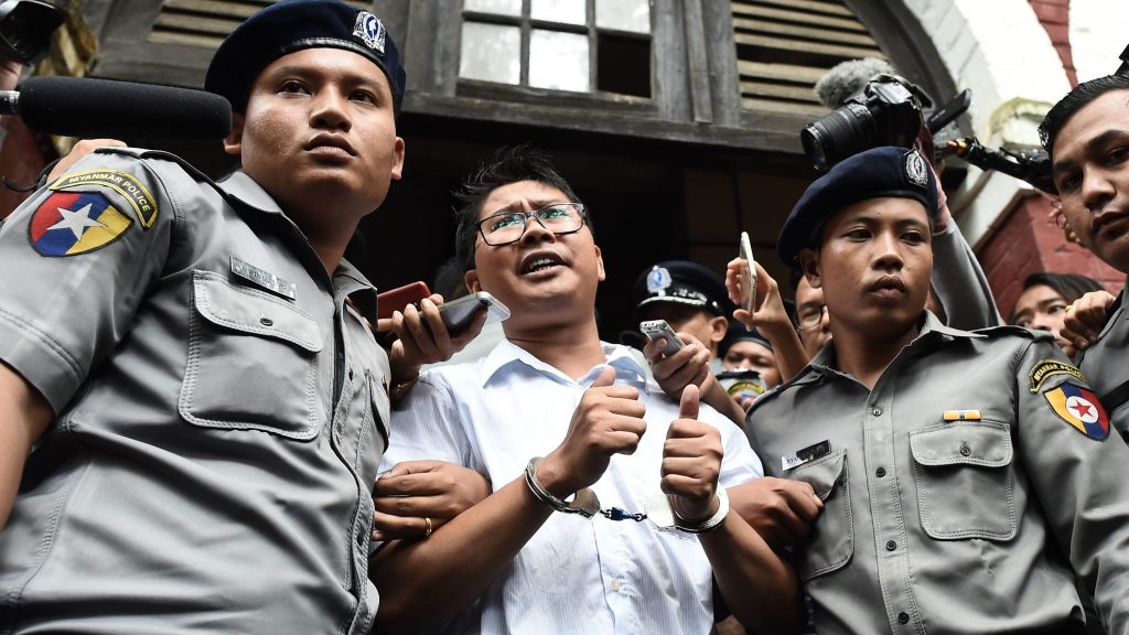 Myanmar journalist Wa Lone (center) is escorted by police after being sentenced by a court to jail in Yangon on Monday. Foreign governments and human rights groups condemned the decision. Myanmar journalist Wa Lone (center) is escorted by police after being sentenced by a court to jail in Yangon on Monday. Foreign governments and human rights groups condemned the decision.