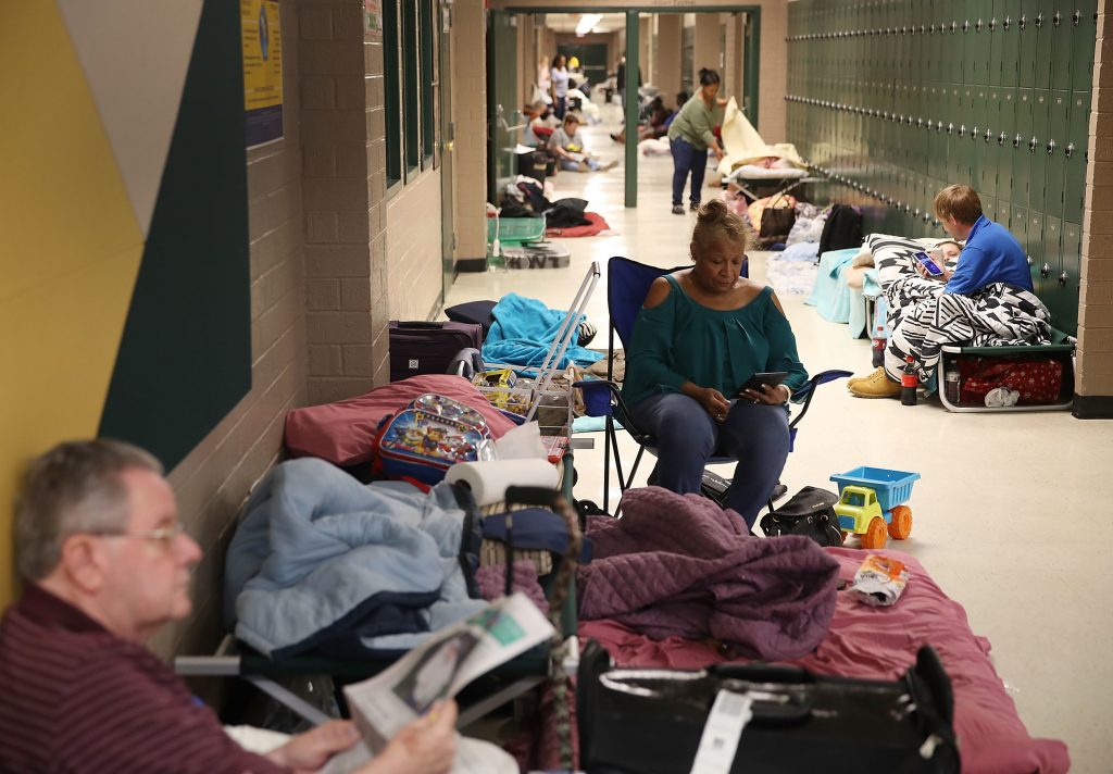 Bob Cavanagh, left, and Linda Moore, center, wait in an evacuation shelter setup at the Conway High School for the arrival of Hurricane Florence on Thursday in Conway, S.C. Many schools in the area have closed or been converted to shelters for residents in the region. Bob Cavanagh, left, and Linda Moore, center, wait in an evacuation shelter setup at the Conway High School for the arrival of Hurricane Florence on Thursday in Conway, S.C. Many schools in the area have closed or been converted to shelters for residents in the region. (Getty)