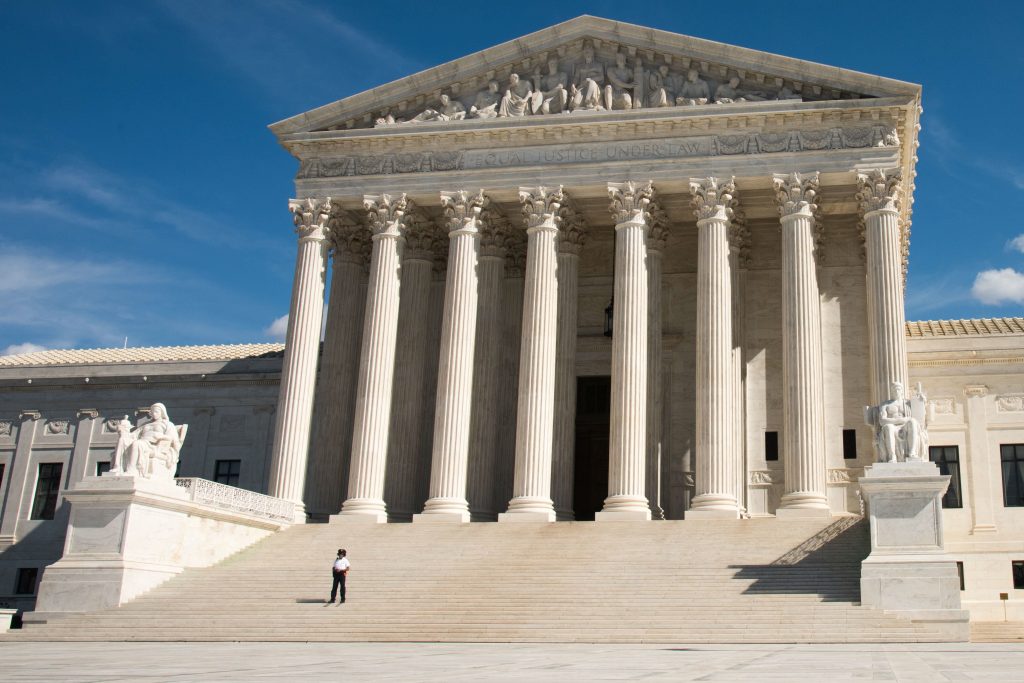 A police officer stands on the steps of the U.S. Supreme Court in Washington, D.C. A police officer stands on the steps of the U.S. Supreme Court in Washington, D.C. (Education Images/UIG via Getty Images)