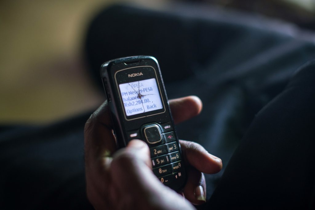 A man checks his phone to confirm that the charity GiveDirectly has transferred a cash grant to his account. A man checks his phone to confirm that the charity GiveDirectly has transferred a cash grant to his account. (Nichole Sobecki for NPR)