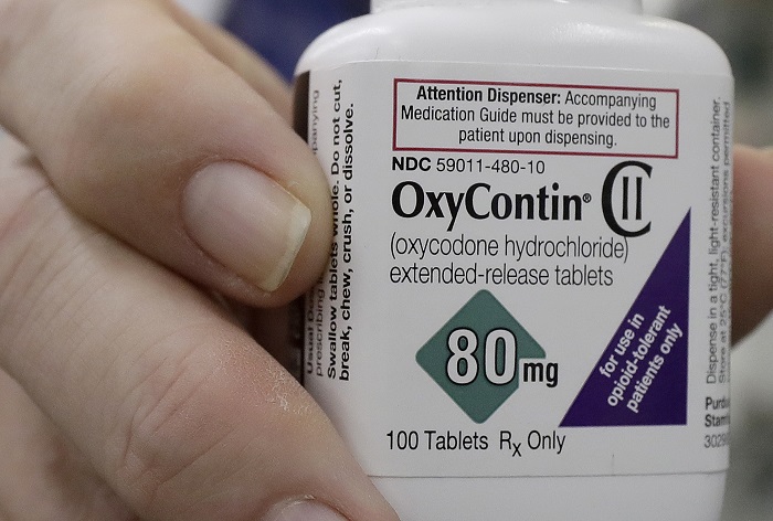 OxyContin In this April 2, 2018 photo, pharmacist Steve Protzel poses for photos holding a bottle of OxyContin at Daniel's Pharmacy in San Francisco. (AP Photo/Jeff Chiu)