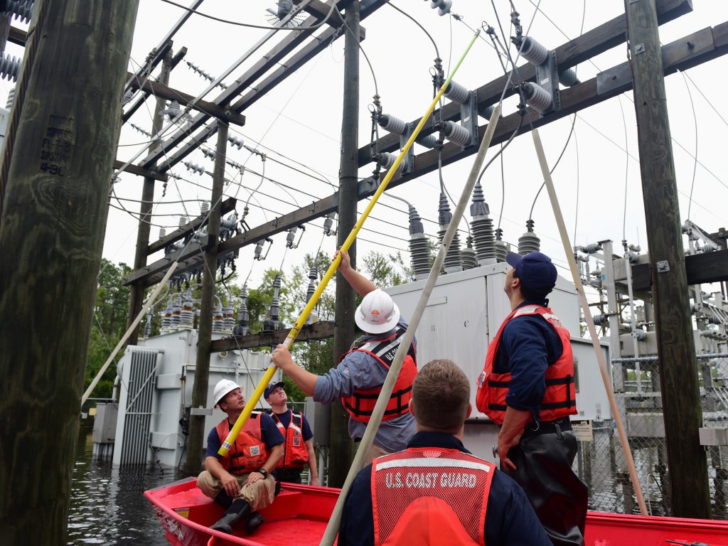 Members of the Coast Guard Shallow-Water Response team escort utility workers to a flooded substation to inspect transformers in Newport, N.C., on Sunday. Members of the Coast Guard Shallow-Water Response team escort utility workers to a flooded substation to inspect transformers in Newport, N.C., on Sunday.