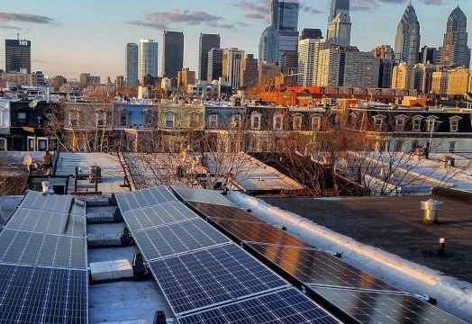 Solar panels and the Philadelphia skyline in winter (Solar States)