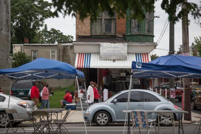 A neighboring street throws their own block party across from the 12th Annual Strawberry Mansion Day in North Philadelphia on Sept. 9, 2018. (Emily Cohen for WHYY)