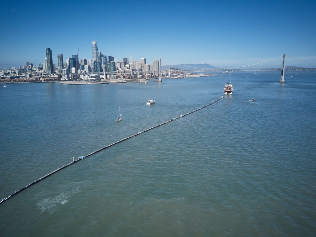 A nearly 2,000-foot-long tube is towed offshore from San Francisco Bay on Saturday. It's a giant garbage collector, and the brainchild of 24-year-old Boyan Slat, who aims to remove 90 percent of ocean plastic by 2040. (The Ocean Cleanup)