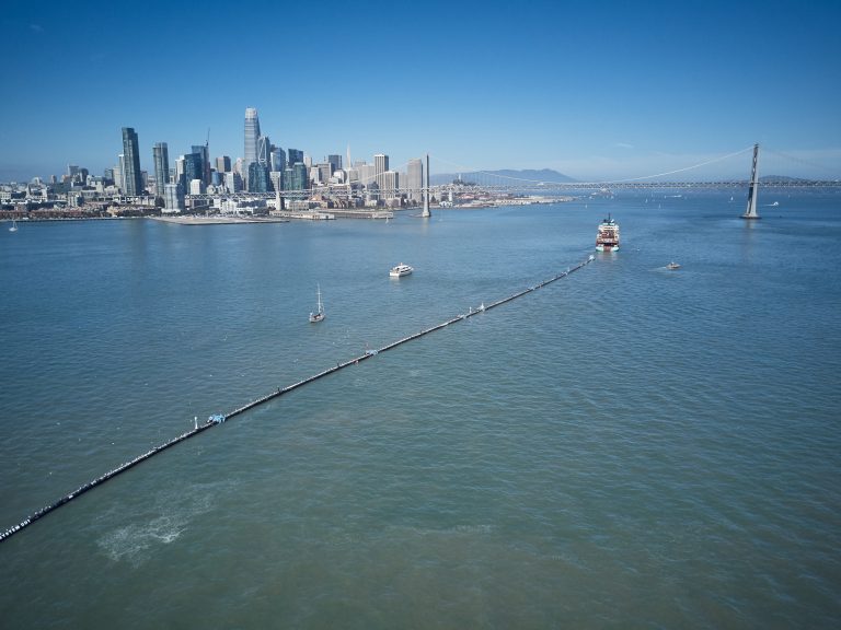 A nearly 2,000-foot-long tube is towed offshore from San Francisco Bay on Saturday. It's a giant garbage collector, and the brainchild of 24-year-old Boyan Slat, who aims to remove 90 percent of ocean plastic by 2040. (The Ocean Cleanup)