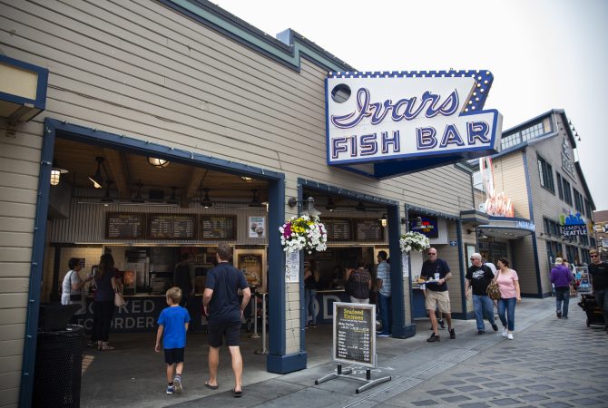 Customers walk up to the Ivar's Fish Bar location, the restaurant's to-go area that's affected by secure scheduling, on the waterfront pier on Wednesday, August 15, 2018 in Seattle, Washington. Ivar's is one of the local businesses affected by Seattle's Secure Scheduling Ordinance, which took effect in July 2017, aiming to establish more predictable work schedules for employees of large retail and food establishments. (Lindsey Wasson for the Inquirer)