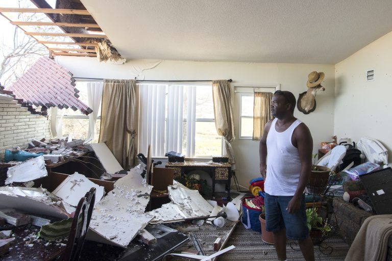 Robert Hill surveys the damage within his living room on Wednesday at Tyndall Air Force Base after Hurricane Michael hit the base last week. Support personnel from Tyndall and other bases were on location to support Airmen returning to their homes to assess damage and collect personal belongings. (Kelly Walker/U.S. Air Force)