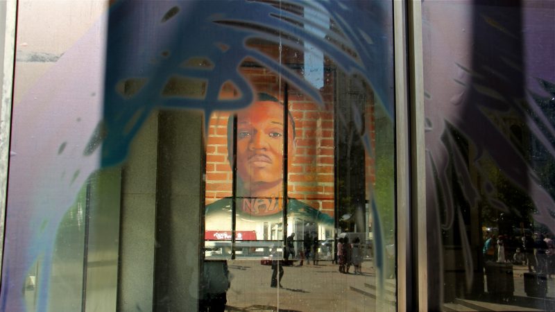 The first floor of the Municipal Services Building is wrapped with the portraits of 17 formerly incarcerated young men and women as part of the Mural Arts 